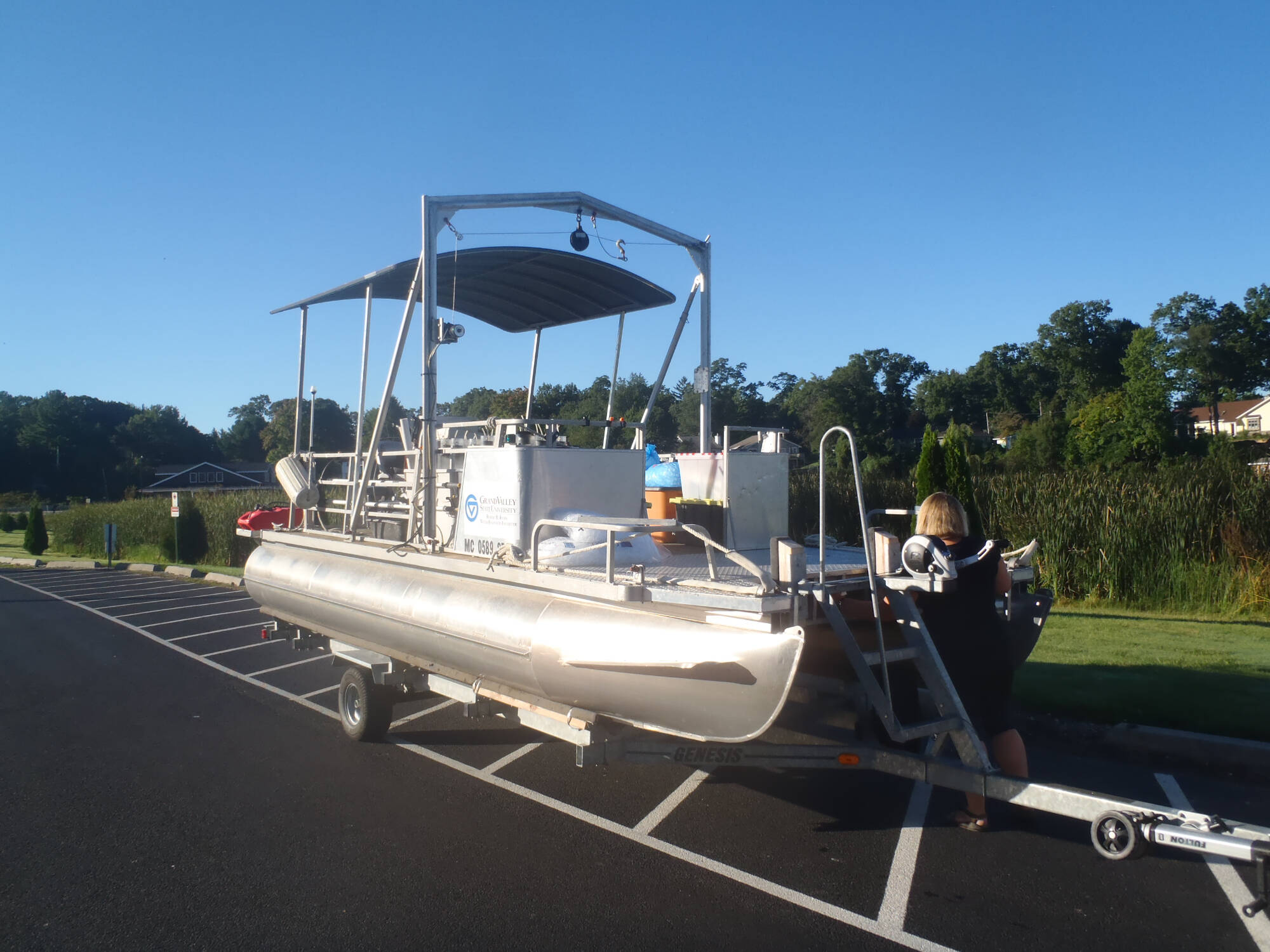The AWRI pontoon being prepared for launch in a boat ramp parking lot.